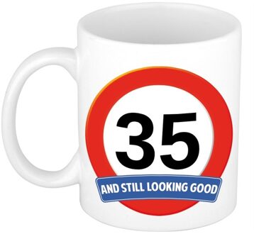 Bellatio Decorations Koffie mok / cadeau beker - 35 jaar - verjaardag - still looking good - wit - stopbord