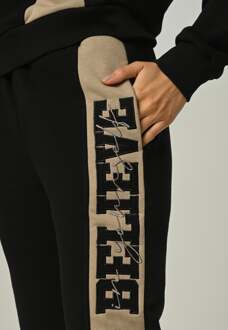 Dames trainingspak Believe met halve rits en applicatie Zwart - XS